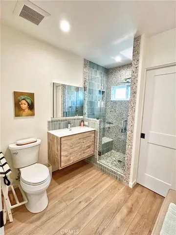 a bathroom with a double vanity sink toilet mirror and bathtub