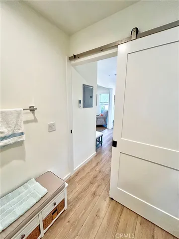 a view of a bedroom with wooden floor