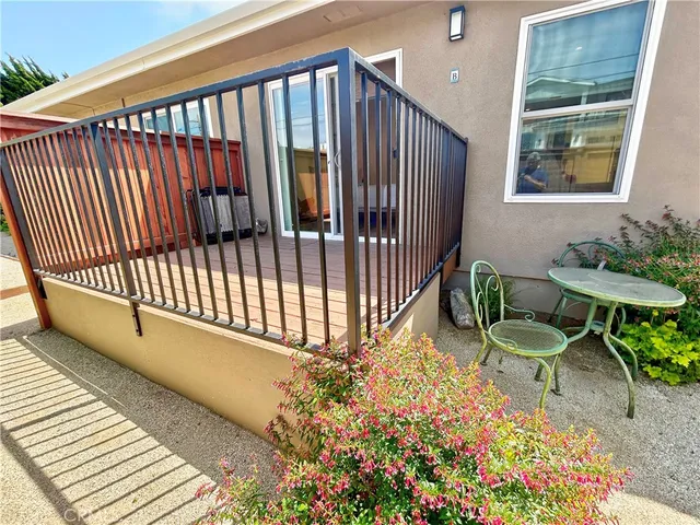 a view of a porch with furniture and garden