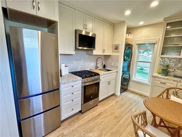 a kitchen with stainless steel appliances a refrigerator stove microwave and sink