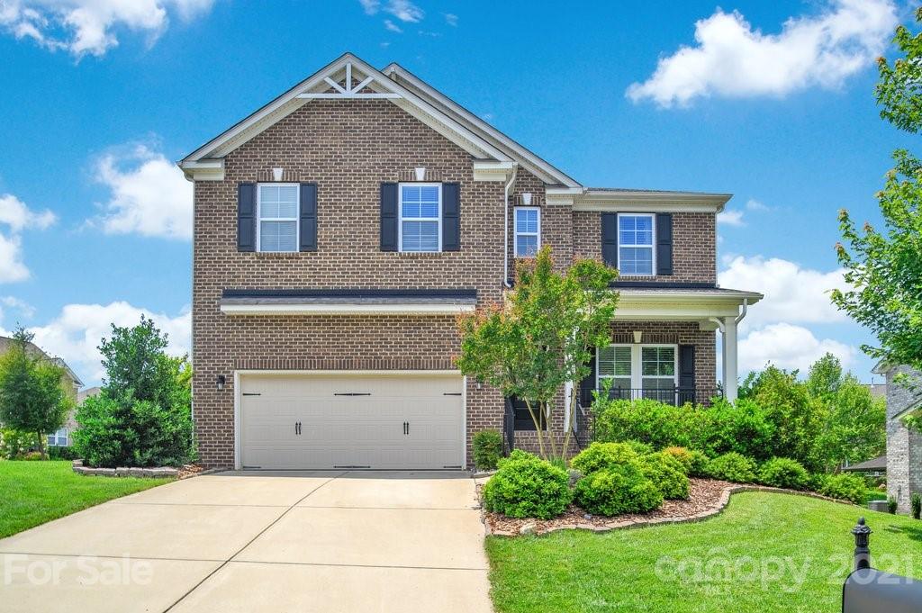 693 Old Cove Road Tega Cay, SC 29708 - Photo 1 of 38 a front view of a house with garden