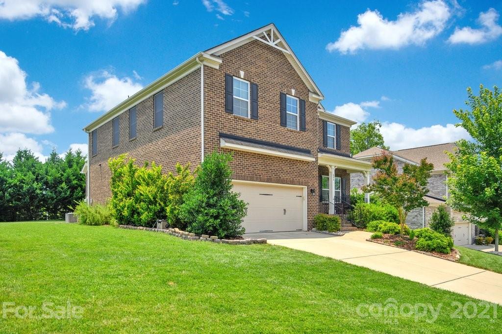 693 Old Cove Road Tega Cay, SC 29708 - Photo 2 of 38 a front view of house with yard and green space
