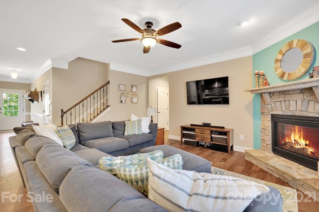 693 Old Cove Road Tega Cay, SC 29708 - Photo 11 of 38 a living room with furniture a flat screen tv and a fireplace