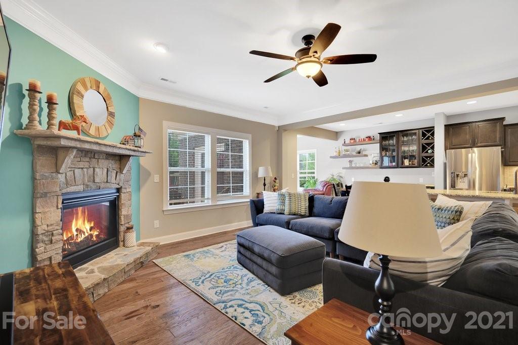 693 Old Cove Road Tega Cay, SC 29708 - Photo 12 of 38 a living room with furniture fireplace and a window