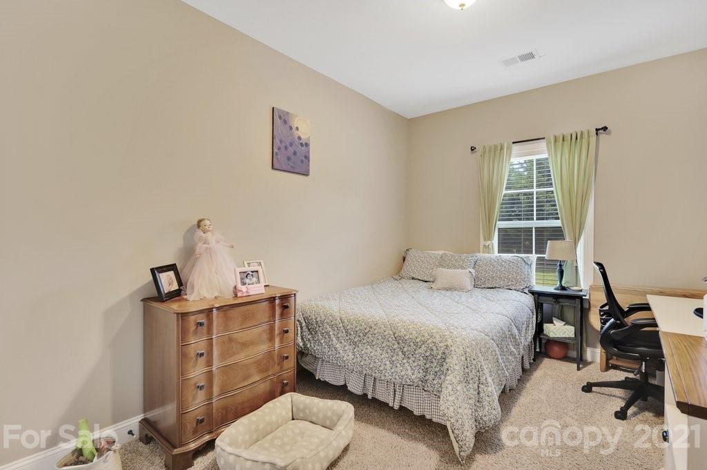 693 Old Cove Road Tega Cay, SC 29708 - Photo 13 of 38 a bedroom with a bed and a window