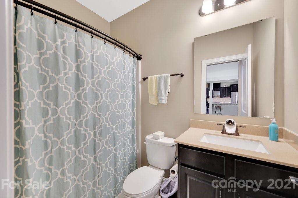 693 Old Cove Road Tega Cay, SC 29708 - Photo 14 of 38 a bathroom with a sink and a mirror