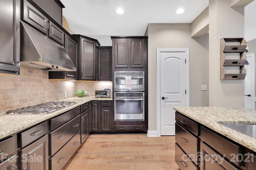 693 Old Cove Road Tega Cay, SC 29708 - Photo 16 of 38 a kitchen with stainless steel appliances granite countertop a refrigerator and a stove