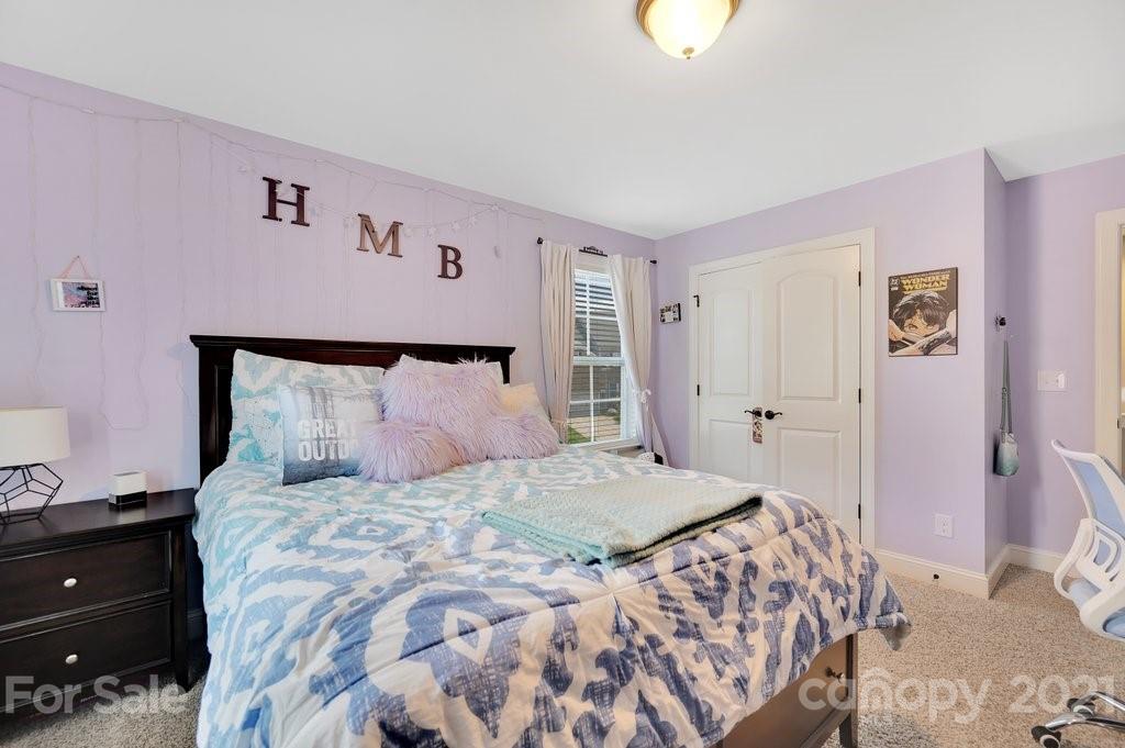 693 Old Cove Road Tega Cay, SC 29708 - Photo 18 of 38 a bedroom with a bed and a lamp on dresser