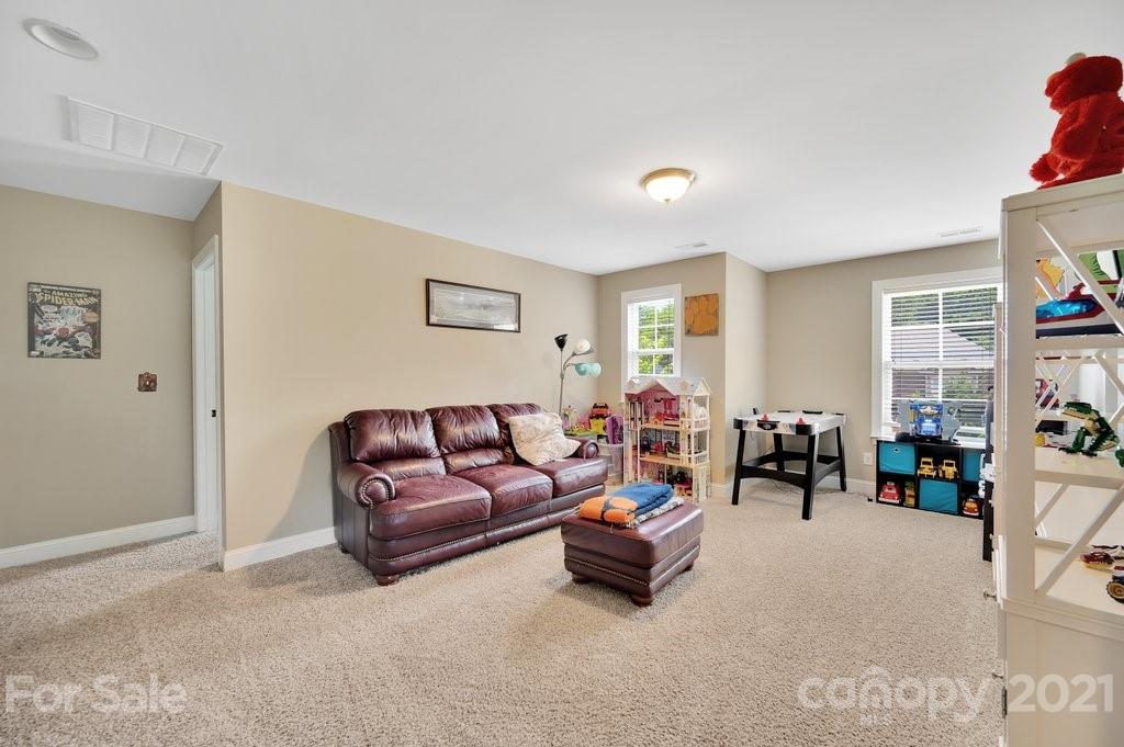 693 Old Cove Road Tega Cay, SC 29708 - Photo 19 of 38 a living room with furniture and a couch