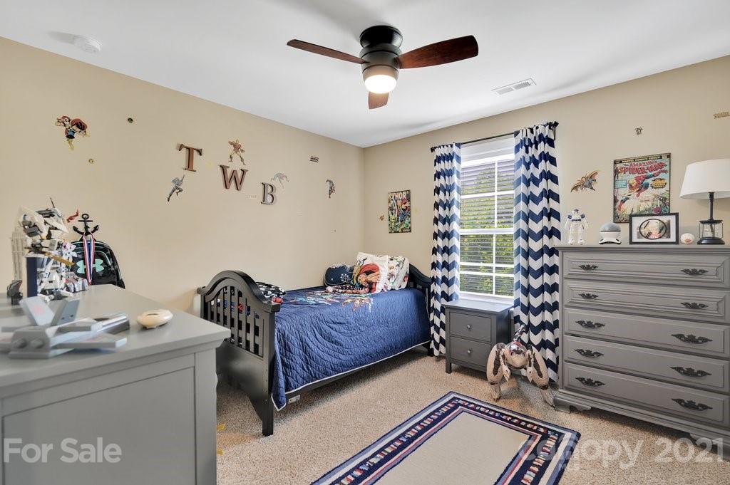 693 Old Cove Road Tega Cay, SC 29708 - Photo 21 of 38 a living room with a bed and a dresser