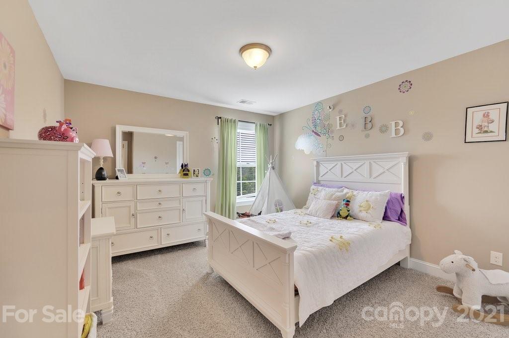 693 Old Cove Road Tega Cay, SC 29708 - Photo 24 of 38 a bedroom with a bed and a dresser