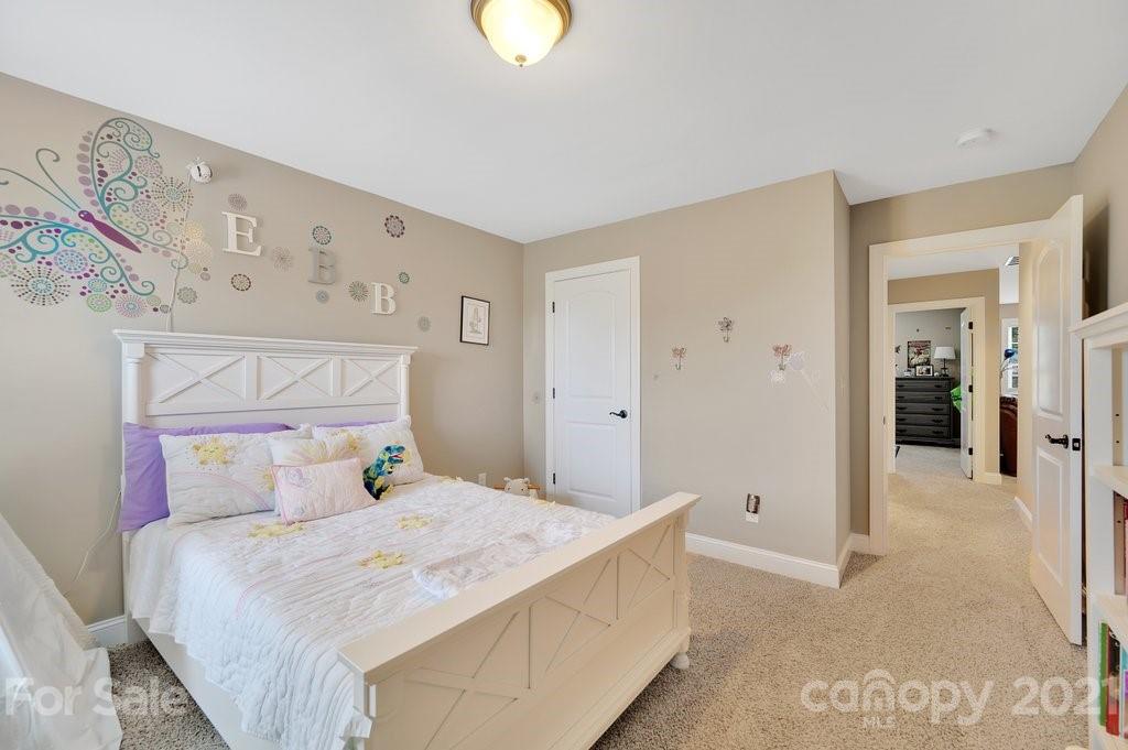 693 Old Cove Road Tega Cay, SC 29708 - Photo 25 of 38 a bedroom with a bed and painting on the wall