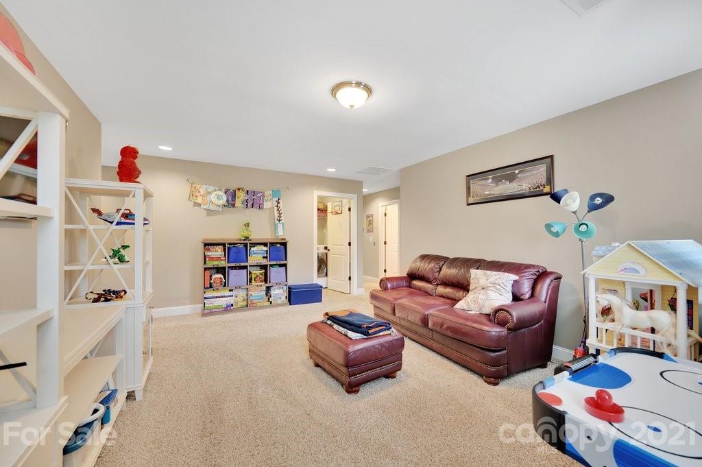 693 Old Cove Road Tega Cay, SC 29708 - Photo 27 of 38 a living room with furniture and baby crib