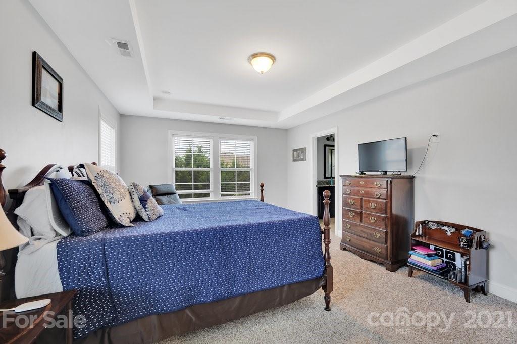 693 Old Cove Road Tega Cay, SC 29708 - Photo 28 of 38 a bedroom with a bed and furniture