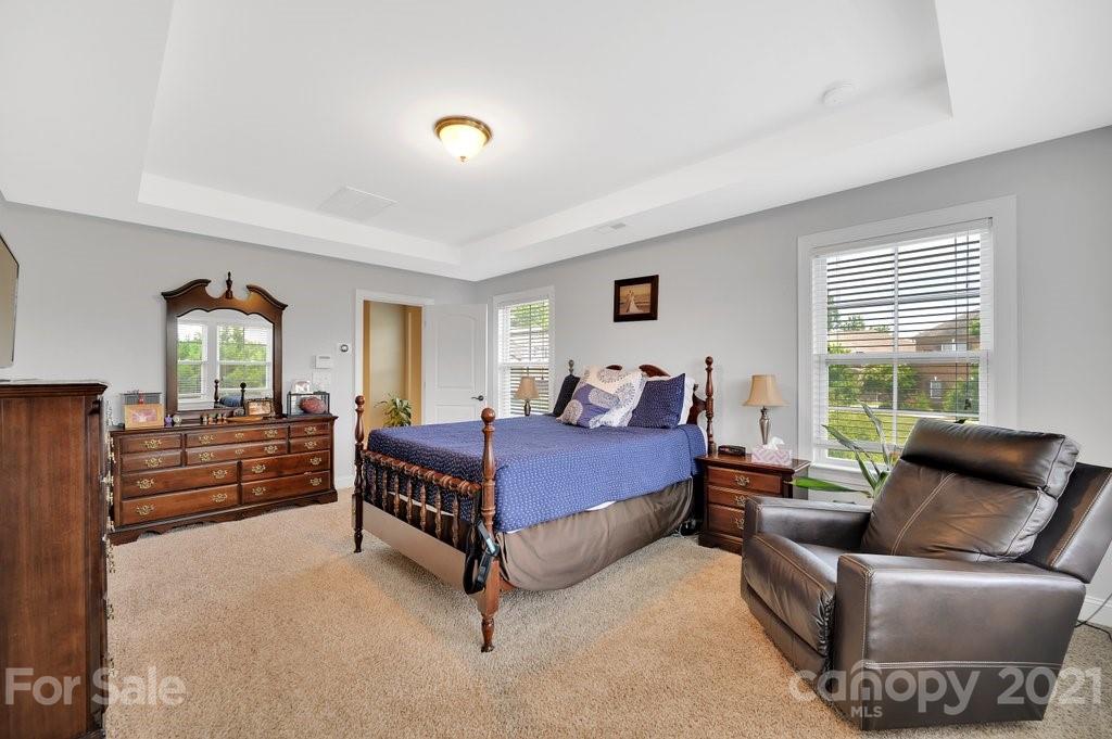 693 Old Cove Road Tega Cay, SC 29708 - Photo 30 of 38 a bedroom with a bed and wooden floor