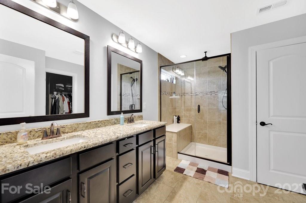 693 Old Cove Road Tega Cay, SC 29708 - Photo 31 of 38 a bathroom with a granite countertop sink mirror and double