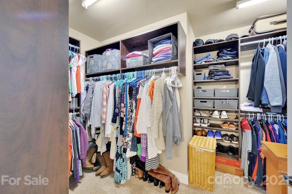 693 Old Cove Road Tega Cay, SC 29708 - Photo 32 of 38 a view of walk in closet with clothes and shoes