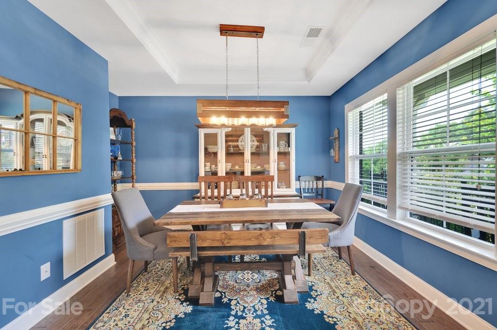 693 Old Cove Road Tega Cay, SC 29708 - Photo 5 of 38 a view of a dining room with furniture window and wooden floor