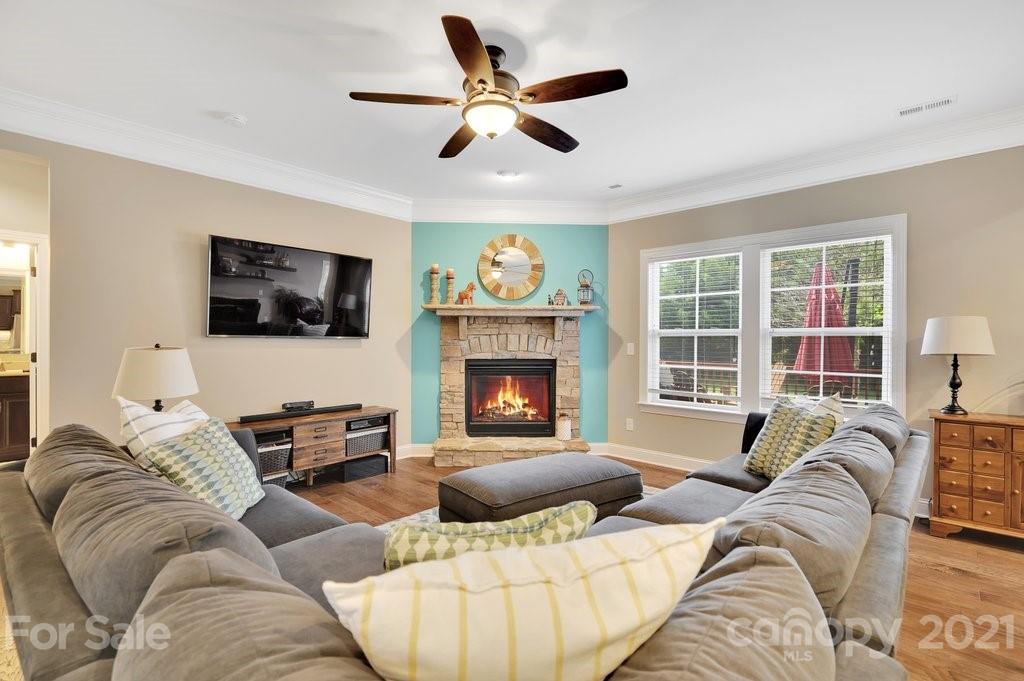 693 Old Cove Road Tega Cay, SC 29708 - Photo 10 of 38 a living room with furniture ceiling fan and a flat screen tv