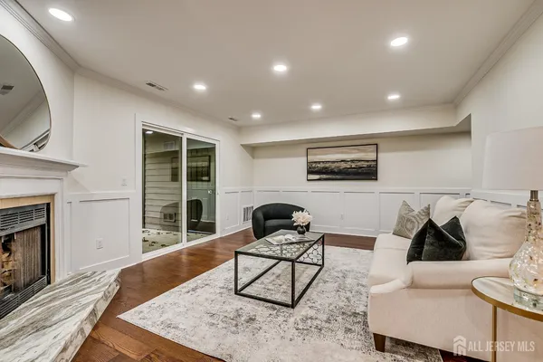 a living room with furniture and a wooden floor