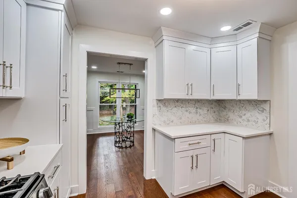 a view of a kitchen with a sink stove and cabinets