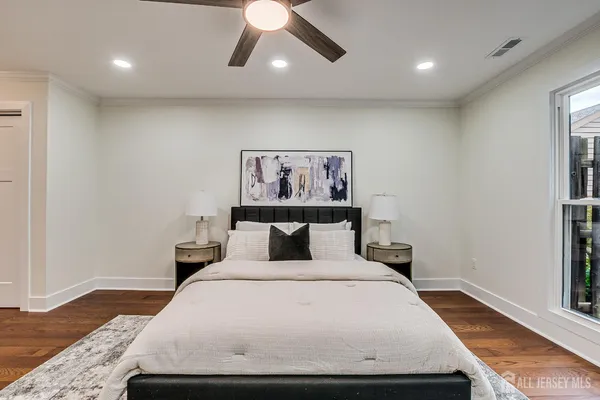 a bedroom with a bed and ceiling fan