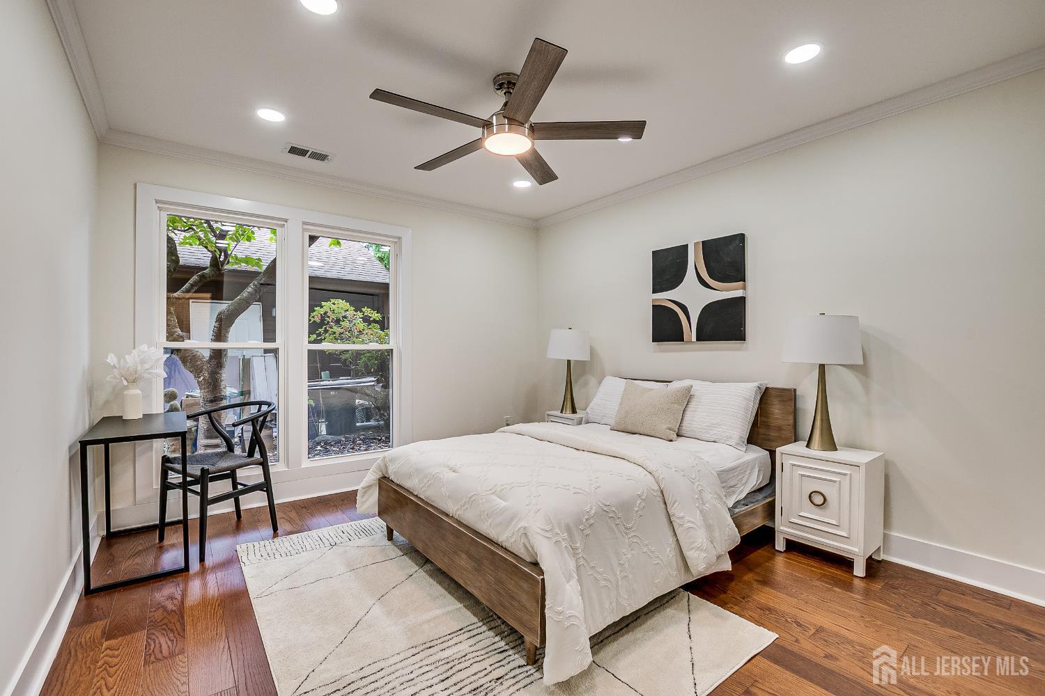 145 Maplewood Court Edison, NJ 08820 - Photo 29 of 37 a bedroom with a bed a table and a potted plant