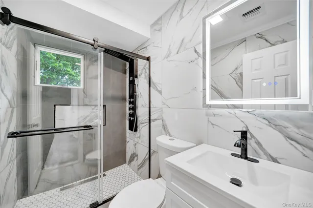 a bathroom with a sink toilet and shower