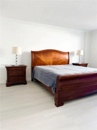 a bedroom with a bed and lamp