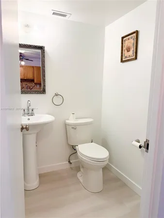a bathroom with a sink toilet and mirror