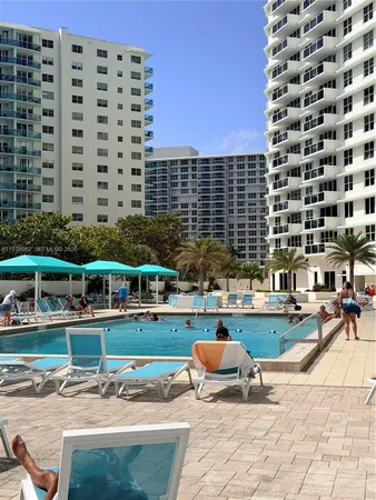 a building outdoor space with swimming pool and furniture