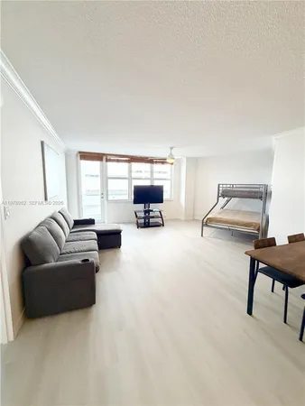 a living room with furniture and a piano