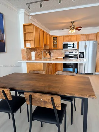 a room with wooden floor a dining table and chairs