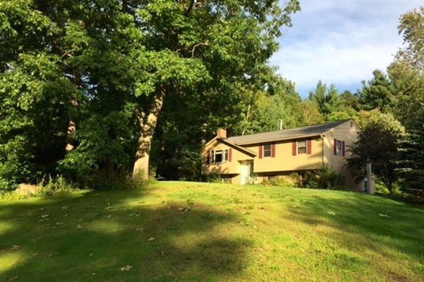 30 Douglas Road Dracut, MA 01826 - Photo 1 of 14 a house that is sitting in the grass with large trees