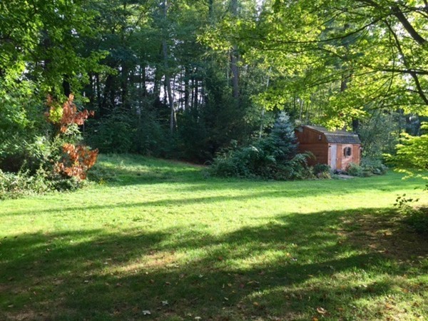 30 Douglas Road Dracut, MA 01826 - Photo 14 of 14 a backyard of a house with lots of green space and outdoor seating