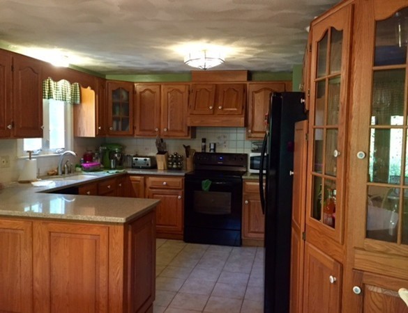 30 Douglas Road Dracut, MA 01826 - Photo 3 of 14 a kitchen with stainless steel appliances granite countertop a refrigerator and a sink