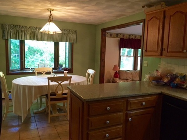 30 Douglas Road Dracut, MA 01826 - Photo 4 of 14 a kitchen with a table chairs and a chandelier