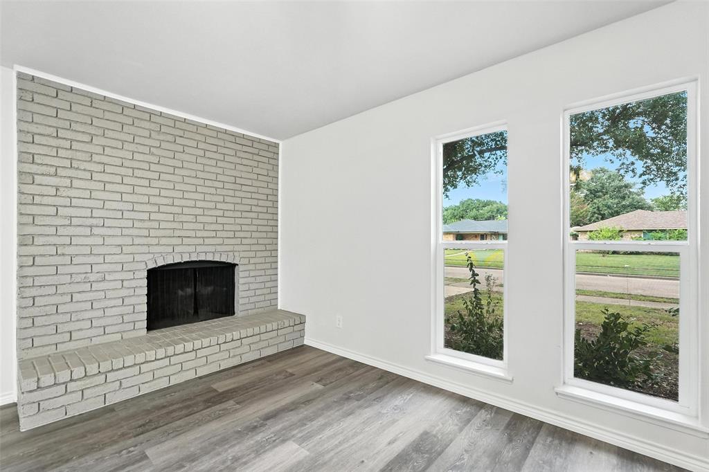 4613 Tarry Drive Garland, TX 75043 - Photo 13 of 38 a view of an empty room with wooden floor and a window