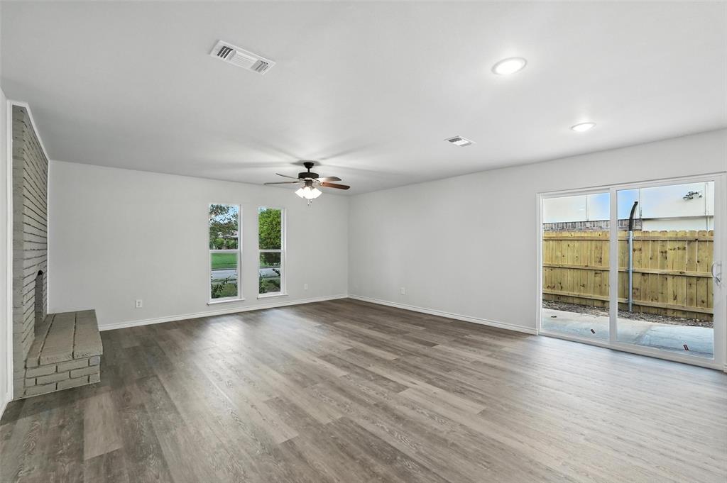 4613 Tarry Drive Garland, TX 75043 - Photo 16 of 38 an empty room with wooden floor and windows