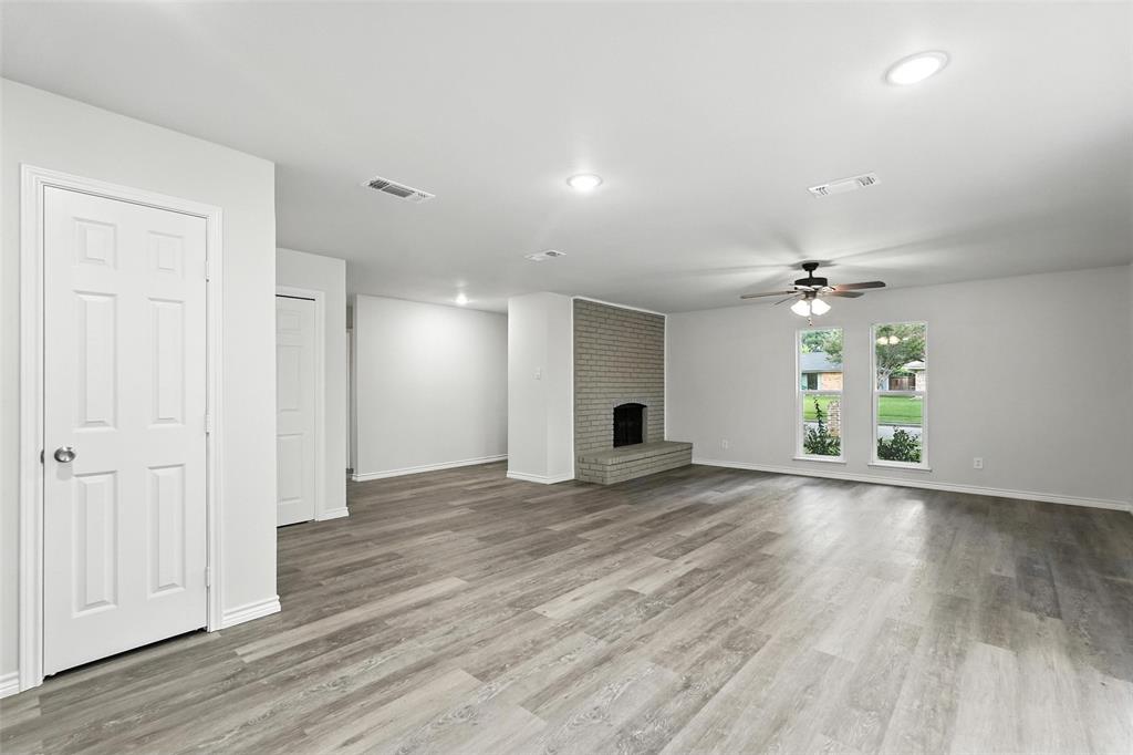 4613 Tarry Drive Garland, TX 75043 - Photo 17 of 38 wooden floor in an empty room with a window
