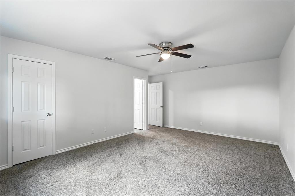 4613 Tarry Drive Garland, TX 75043 - Photo 21 of 38 a view of an empty room with a ceiling fan