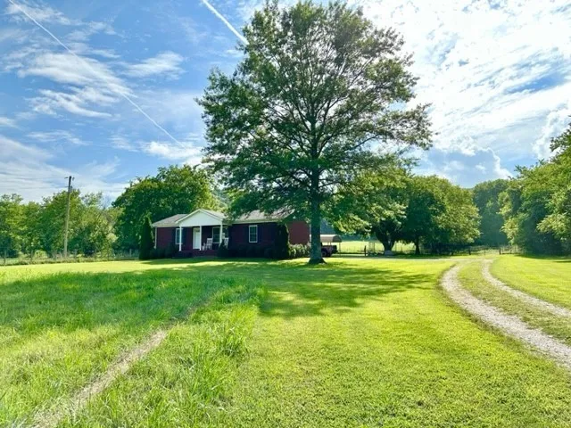 a view of a house with a backyard