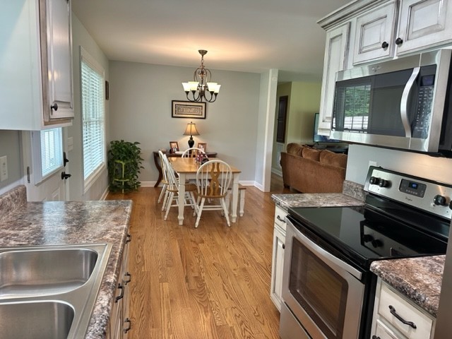 2244 Baptist Branch Road Mount Pleasant, TN 38474 - Photo 33 of 47 a kitchen with stainless steel appliances granite countertop a sink stove and refrigerator