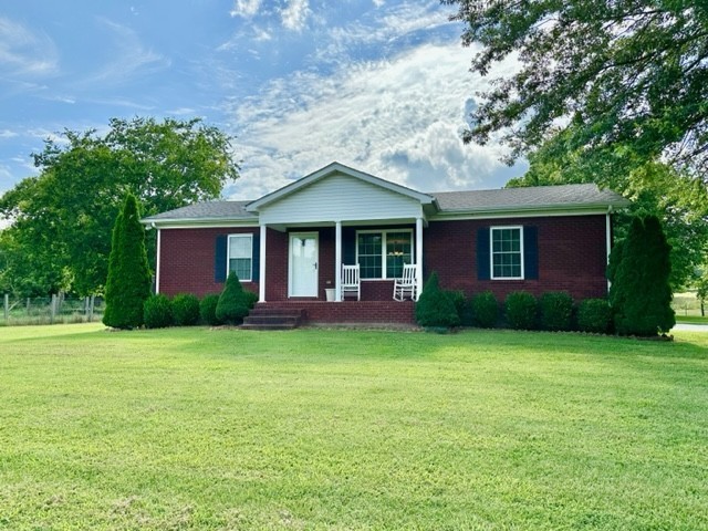 2244 Baptist Branch Road Mount Pleasant, TN 38474 - Photo 8 of 47 a front view of a house with a garden
