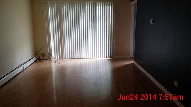 904 Ridge Square, Unit 105 Elk Grove Village, IL 60007 - Photo 4 of 12 an empty room with wooden floor