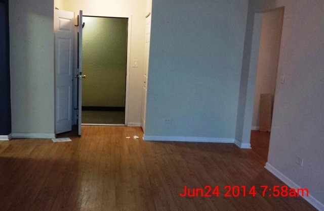 904 Ridge Square, Unit 105 Elk Grove Village, IL 60007 - Photo 6 of 12 an empty room with wooden floor and closet