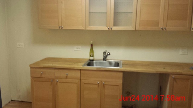 904 Ridge Square, Unit 105 Elk Grove Village, IL 60007 - Photo 7 of 12 a kitchen with a sink and cabinets