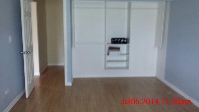904 Ridge Square, Unit 105 Elk Grove Village, IL 60007 - Photo 10 of 12 a view of hallway with wooden floor