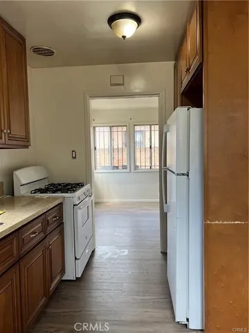 a kitchen with granite countertop a refrigerator and a stove