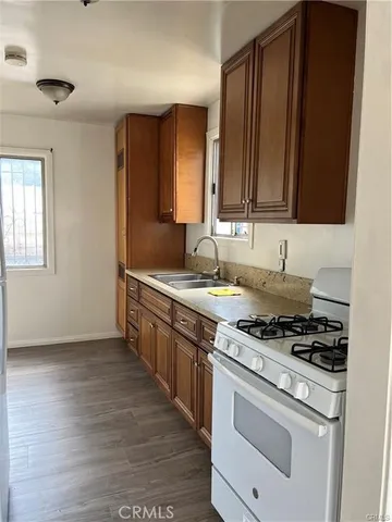 a kitchen with wooden cabinets and a stove top oven